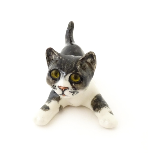 158 - A Winstanley model of a playful black and white kitten / cat, size 3. Marked under. Approx. 9