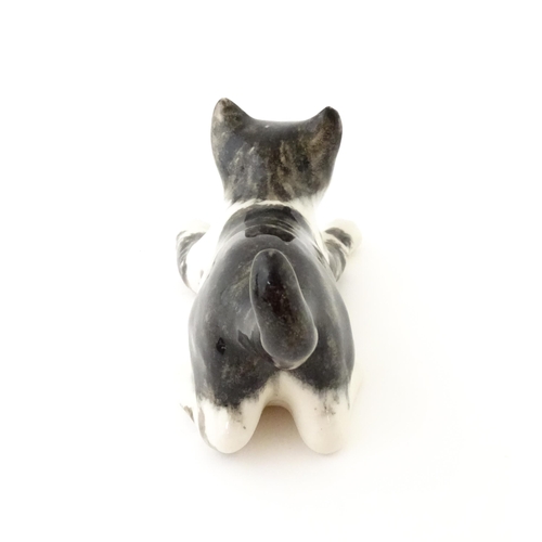 158 - A Winstanley model of a playful black and white kitten / cat, size 3. Marked under. Approx. 9