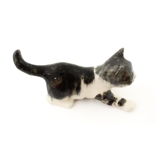 158 - A Winstanley model of a playful black and white kitten / cat, size 3. Marked under. Approx. 9