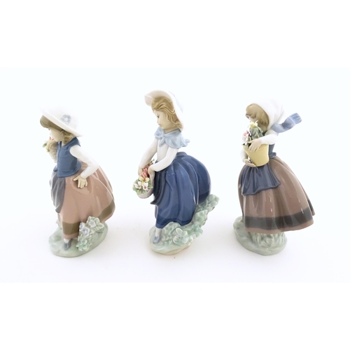 180 - Three Lladro figures comprising Sweet Scent model no. 5221, Pretty Pickings no. 5222, and Spring is ... 