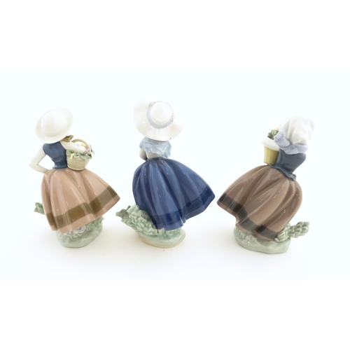 180 - Three Lladro figures comprising Sweet Scent model no. 5221, Pretty Pickings no. 5222, and Spring is ... 