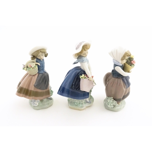 180 - Three Lladro figures comprising Sweet Scent model no. 5221, Pretty Pickings no. 5222, and Spring is ... 