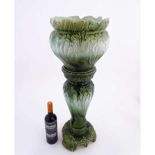 187 - A Victorian jardiniere and stand with green glaze and foliate decoration. Marked under Princess with... 