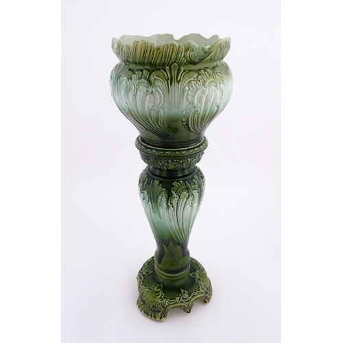 187 - A Victorian jardiniere and stand with green glaze and foliate decoration. Marked under Princess with... 