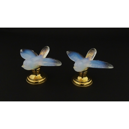 211 - A pair of glass models of swallows raised on French silver gilt stands, stamped Odiot. Approx. 2 1/4... 