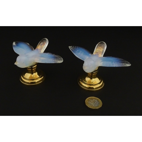 211 - A pair of glass models of swallows raised on French silver gilt stands, stamped Odiot. Approx. 2 1/4... 