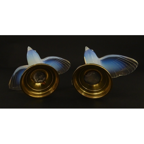 211 - A pair of glass models of swallows raised on French silver gilt stands, stamped Odiot. Approx. 2 1/4... 