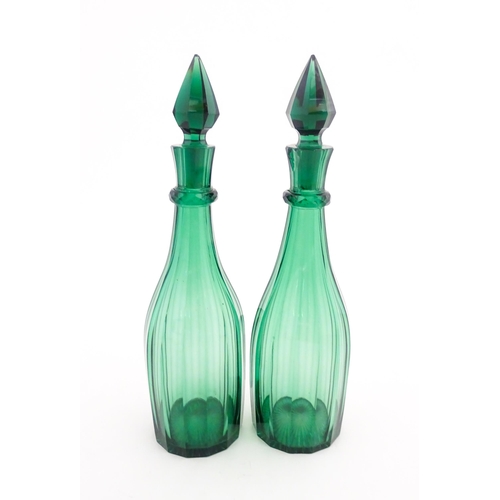 244 - A pair of 19thC green glass decanters and stoppers. Approx. 14