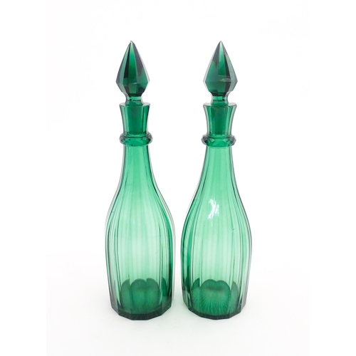 244 - A pair of 19thC green glass decanters and stoppers. Approx. 14