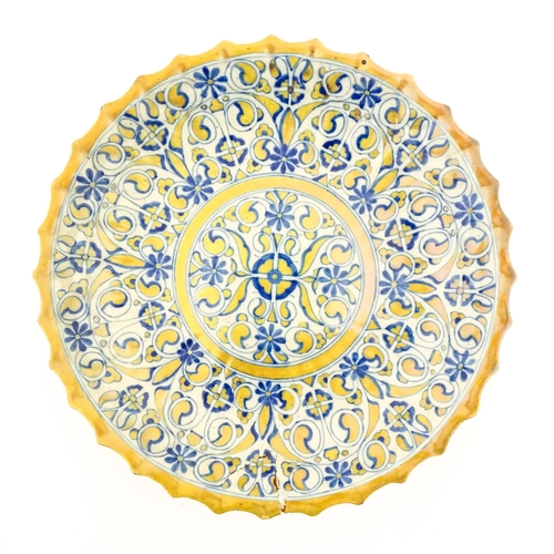 69 - An Italian Cantagalli lustre charger decorated with scrolling floral and foliate detail in blue and ... 