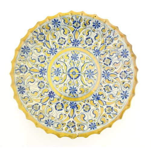 69 - An Italian Cantagalli lustre charger decorated with scrolling floral and foliate detail in blue and ... 