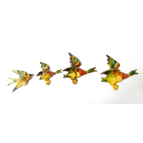 1083 - Three 20thC Parkside cast graduated wall plaques modelled as ducks in flight. Together with a cast s... 