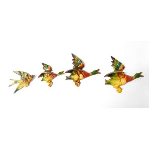 1083 - Three 20thC Parkside cast graduated wall plaques modelled as ducks in flight. Together with a cast s... 