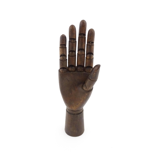 1101 - A 20thC artist's wooden lay hand with articulated fingers. Approx. 10 1/4