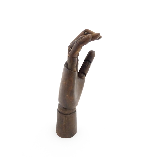 1101 - A 20thC artist's wooden lay hand with articulated fingers. Approx. 10 1/4