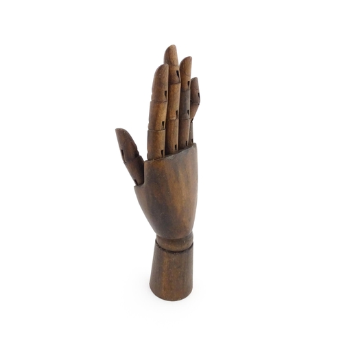 1101 - A 20thC artist's wooden lay hand with articulated fingers. Approx. 10 1/4