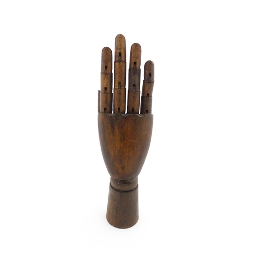 1101 - A 20thC artist's wooden lay hand with articulated fingers. Approx. 10 1/4