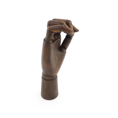 1101 - A 20thC artist's wooden lay hand with articulated fingers. Approx. 10 1/4