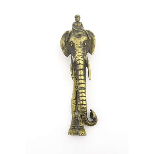 1103 - An early 20thC brass door knocker formed as a stylised elephant and rider, marked Africa. Approx. 7