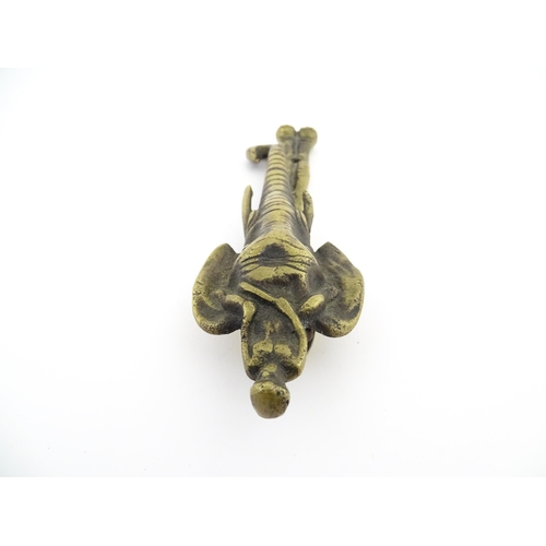 1103 - An early 20thC brass door knocker formed as a stylised elephant and rider, marked Africa. Approx. 7