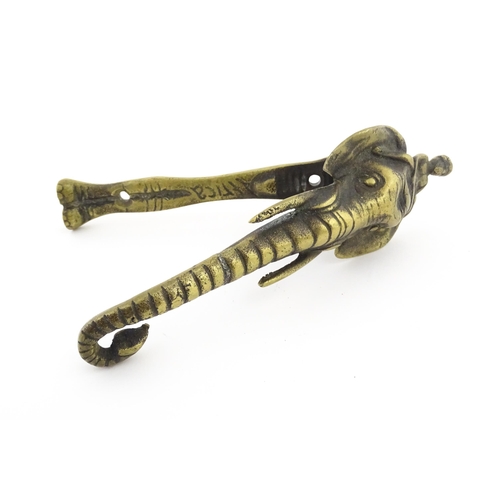 1103 - An early 20thC brass door knocker formed as a stylised elephant and rider, marked Africa. Approx. 7