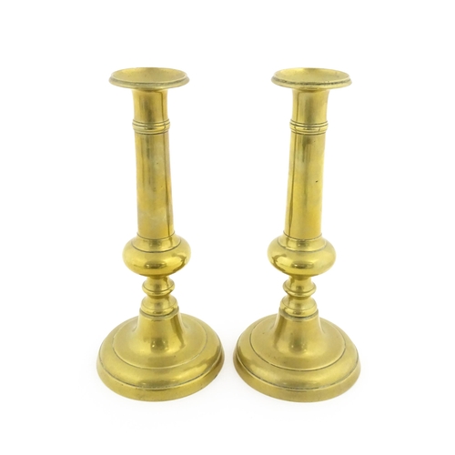 1104 - A pair of Victorian brass plunger candlesticks with knop detail to stems. Approx. 10 1/2