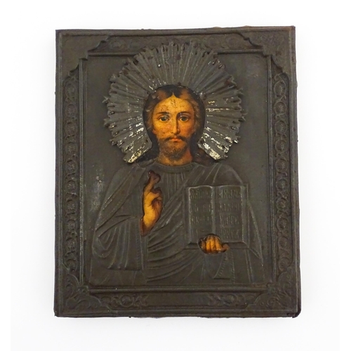 1106 - An early 20thC Russian icon depicting Christ Pantocrator with an embossed silver plate surround. App... 