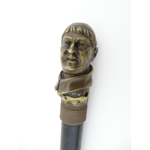 1109 - A 20thC cast cane top modelled as the head of a cardinal / priest mounted on a short stick. Approx. ... 