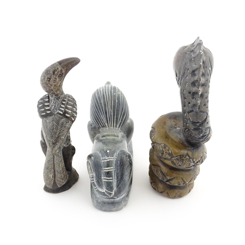 1113 - Three 20thC soapstone carvings to include a coiled snake, a stylised bird and a sphinx. Snake approx... 