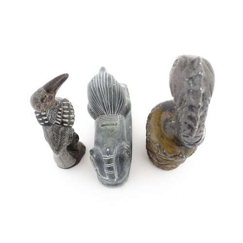 1113 - Three 20thC soapstone carvings to include a coiled snake, a stylised bird and a sphinx. Snake approx... 