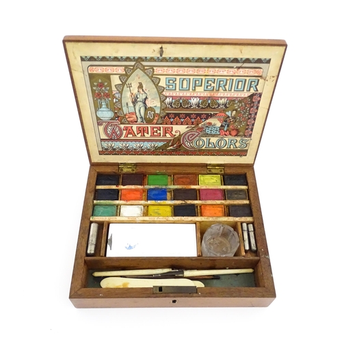 1116 - A late 19th / early 20thC artist's wooden paint box with paper label to interior lid for Superior Wa... 