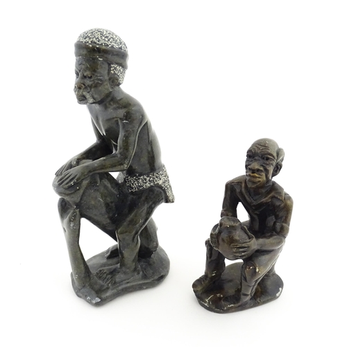 1127 - Ethnographic / Native / Tribal : An African soapstone carving modelled as a tribesman playing a drum... 