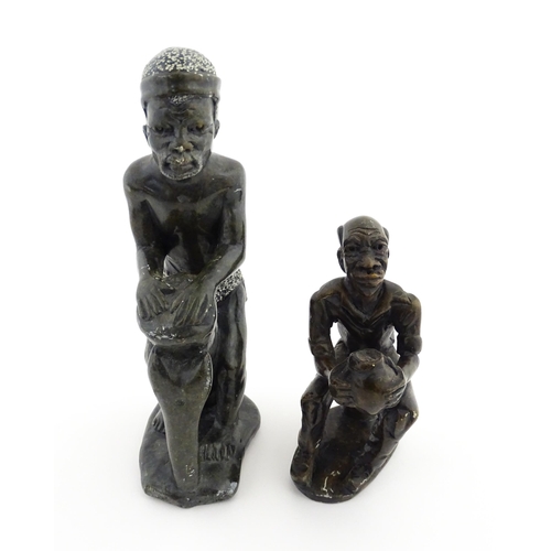 1127 - Ethnographic / Native / Tribal : An African soapstone carving modelled as a tribesman playing a drum... 