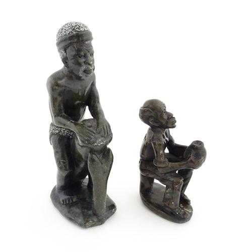 1127 - Ethnographic / Native / Tribal : An African soapstone carving modelled as a tribesman playing a drum... 