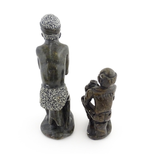 1127 - Ethnographic / Native / Tribal : An African soapstone carving modelled as a tribesman playing a drum... 