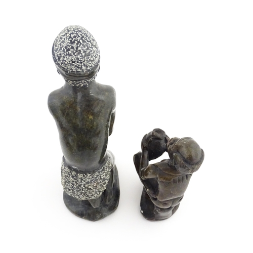 1127 - Ethnographic / Native / Tribal : An African soapstone carving modelled as a tribesman playing a drum... 