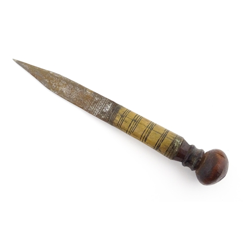 1128 - Ethnographic / Native / Tribal : An African dagger / knife with a wooden handle, the blade with engr... 