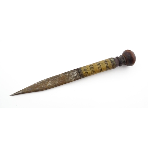 1128 - Ethnographic / Native / Tribal : An African dagger / knife with a wooden handle, the blade with engr... 