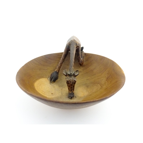 1129 - Ethnographic / Native / Tribal : An African wooden bowl with carved drinking giraffe detail. Numbere... 