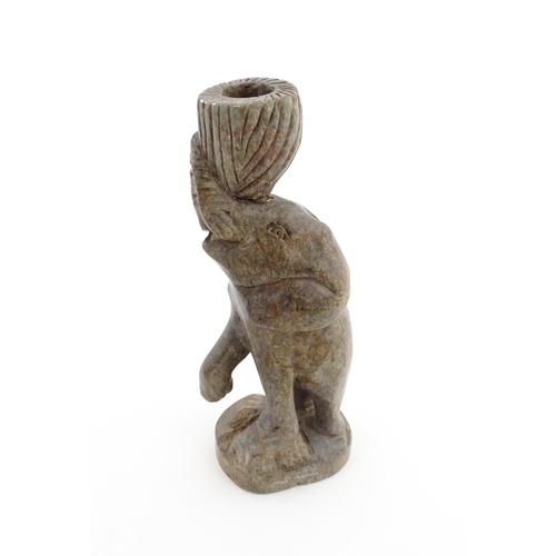 1130 - Ethnographic / Native / Tribal : An African carved soapstone candlestick formed as an elephant holdi... 