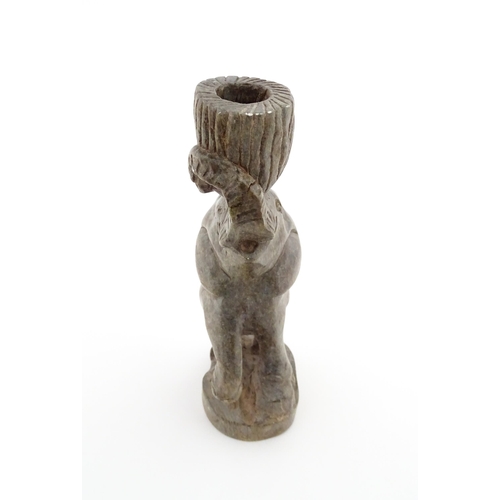 1130 - Ethnographic / Native / Tribal : An African carved soapstone candlestick formed as an elephant holdi... 