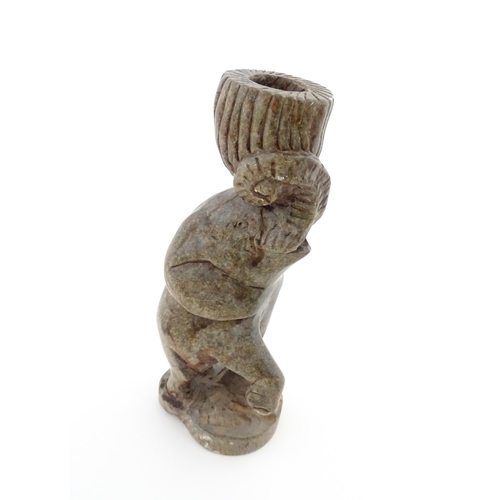 1130 - Ethnographic / Native / Tribal : An African carved soapstone candlestick formed as an elephant holdi... 