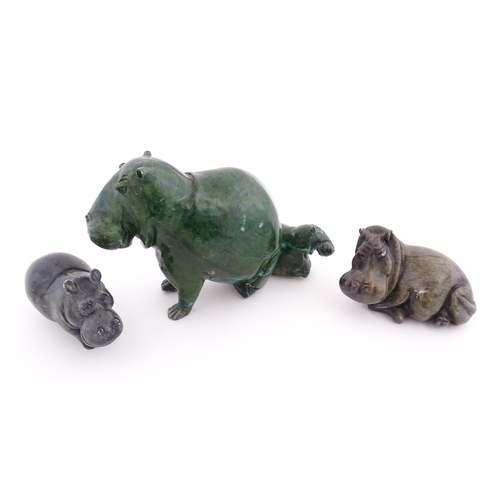 1133 - A carved hippo / hippopotamus and calf. Together with two carved soapstone hippos. Largest approx. 8... 