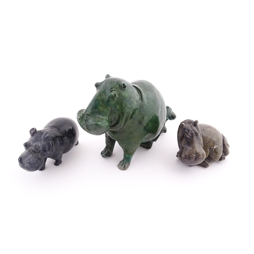 1133 - A carved hippo / hippopotamus and calf. Together with two carved soapstone hippos. Largest approx. 8... 