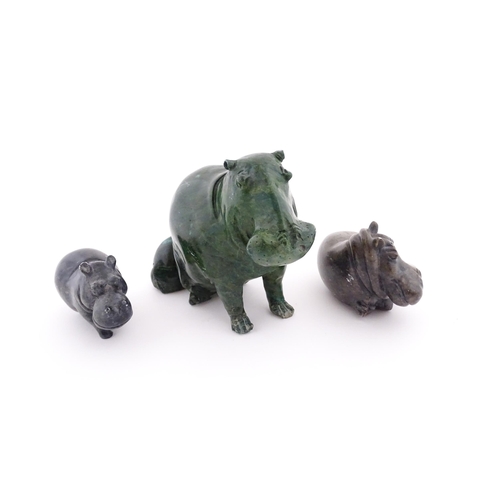 1133 - A carved hippo / hippopotamus and calf. Together with two carved soapstone hippos. Largest approx. 8... 