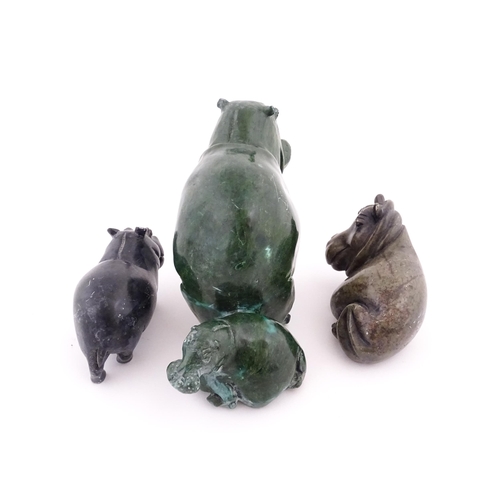 1133 - A carved hippo / hippopotamus and calf. Together with two carved soapstone hippos. Largest approx. 8... 