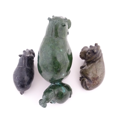 1133 - A carved hippo / hippopotamus and calf. Together with two carved soapstone hippos. Largest approx. 8... 