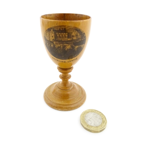 1146 - A 19thC Mauchline ware egg cup with a vignette depicting Stirling Castle. Approx. 3 1/4