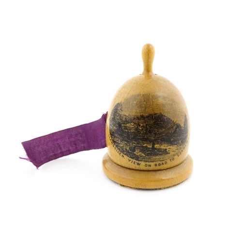 1150 - A 19thC Mauchline ware sewing tape measure of dome form with a vignette depicting Llangollen, View o... 