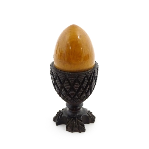 1152 - A 19thC treen / turned wooden thimble case and sewing thread holder of egg cup form, containing an e... 